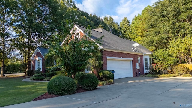 view of home's exterior featuring a garage and a lawn