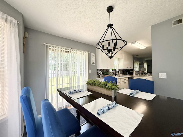 101 Maple Valley Dr, Madison, AL 35758 - dining room with a chandelier and a textured ceiling