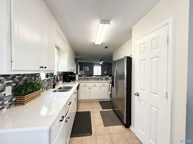 101 Maple Valley Dr, Madison, AL 35758 - kitchen with stainless steel refrigerator with ice dispenser, tasteful backsplash, light tile patterned floors, white cabinetry, and a textured ceiling