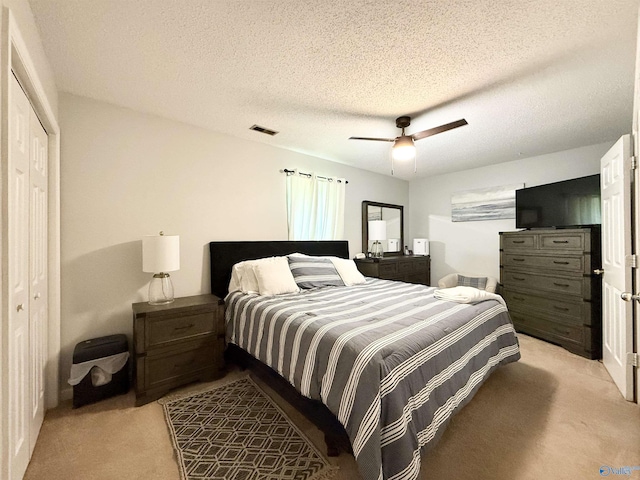 101 Maple Valley Dr, Madison, AL 35758 - bedroom with light carpet, ceiling fan, a closet, and a textured ceiling