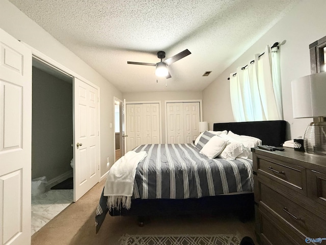 101 Maple Valley Dr, Madison, AL 35758 - bedroom featuring two closets, a textured ceiling, a ceiling fan, and marble finish floors