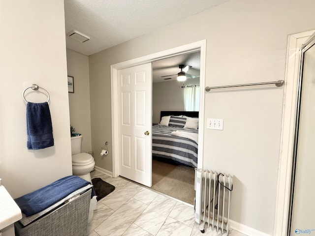 101 Maple Valley Dr, Madison, AL 35758 - ensuite bathroom with marble finish floors, radiator, a shower with door, ceiling fan, and a textured ceiling