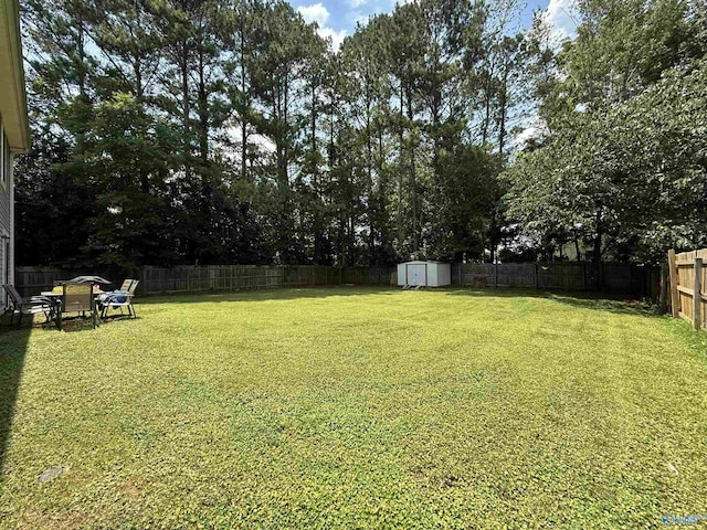 101 Maple Valley Dr, Madison, AL 35758 - fenced backyard featuring a storage shed and view of wooded area