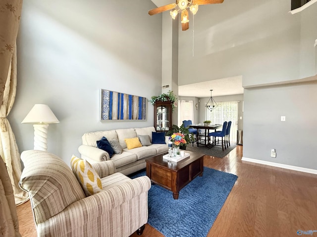 101 Maple Valley Dr, Madison, AL 35758 - living area with wood finished floors, a ceiling fan, and a high ceiling