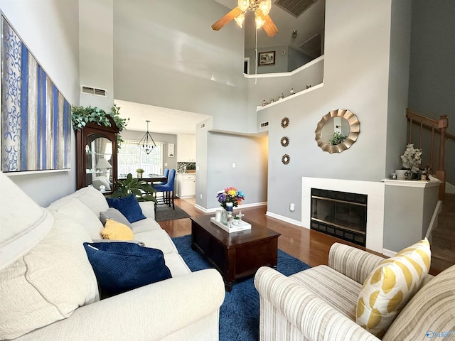 101 Maple Valley Dr, Madison, AL 35758 - living area featuring wood finished floors, a high ceiling, a ceiling fan, and a tile fireplace