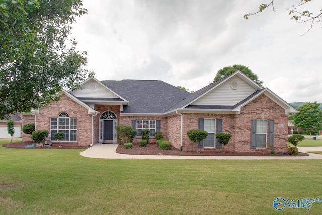 2704 Wenzel Cir, Owens Cross Roads, AL 35763 - view of front of house with brick siding, a front yard, and a shingled roof