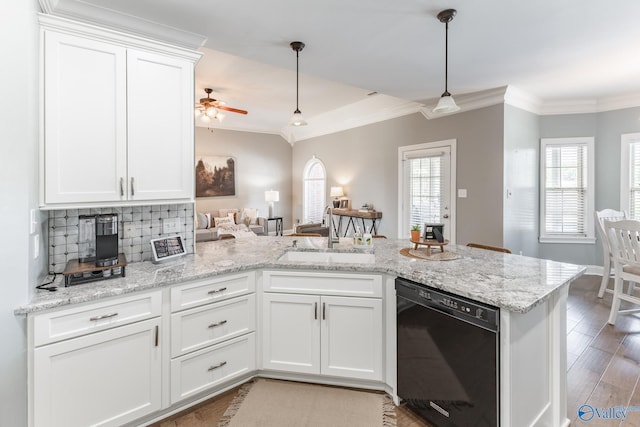 kitchen featuring white cabinetry, sink, decorative light fixtures, and black dishwasher