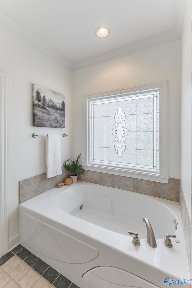 bathroom with ornamental molding, a washtub, and tile patterned floors