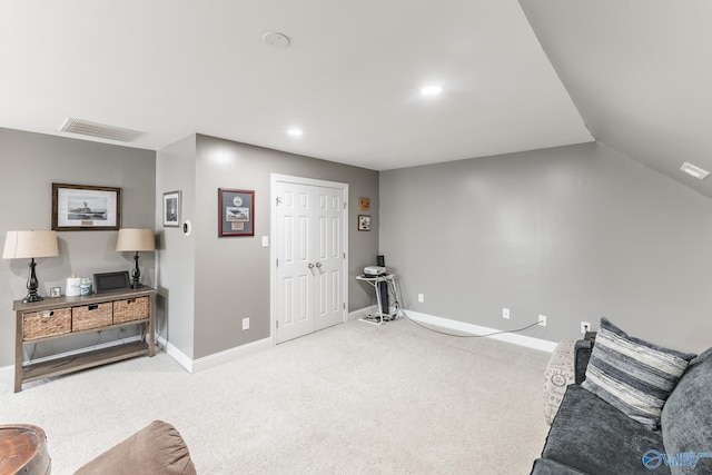 living area featuring vaulted ceiling and carpet