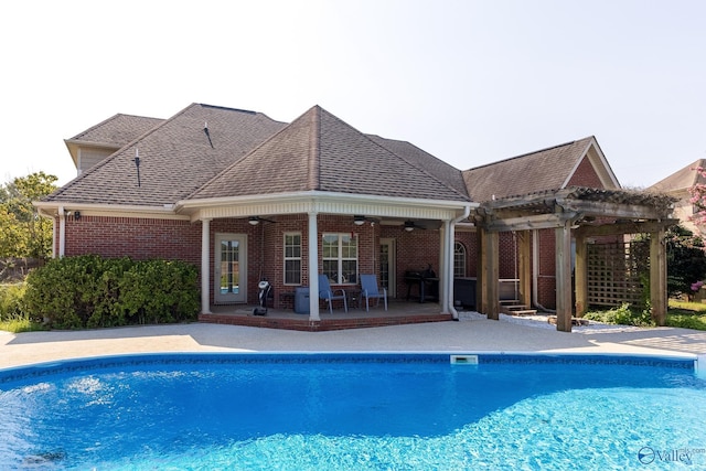 view of pool with a pergola, a patio, and ceiling fan