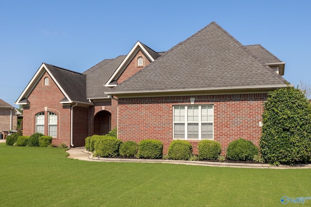 view of property featuring a front lawn