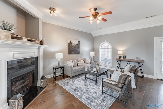 living room with ceiling fan, ornamental molding, and dark hardwood / wood-style flooring