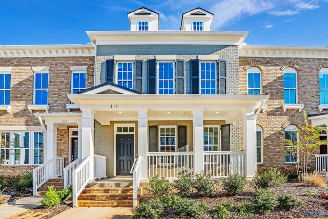 townhome / multi-family property featuring a porch