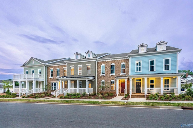 townhome / multi-family property with covered porch