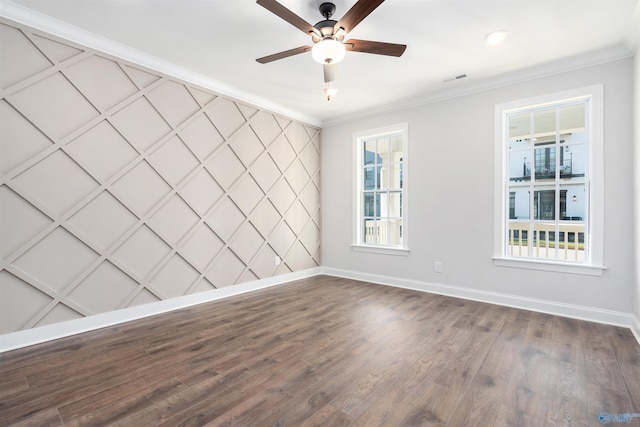 unfurnished room featuring a wealth of natural light, ornamental molding, dark hardwood / wood-style floors, and ceiling fan