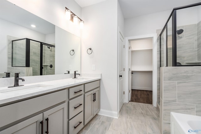 bathroom with vanity and shower with separate bathtub