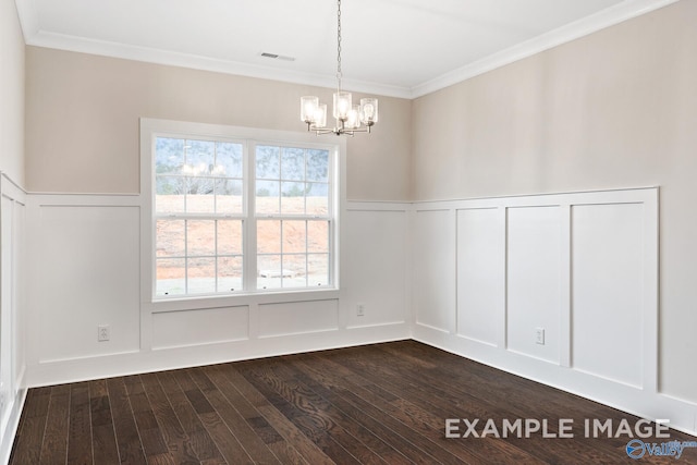 unfurnished dining area featuring visible vents, a decorative wall, dark wood-type flooring, ornamental molding, and a chandelier