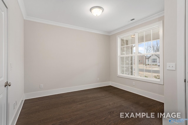 empty room with dark wood-style floors, baseboards, and crown molding