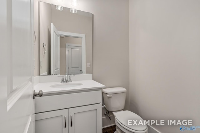 half bath featuring toilet and vanity