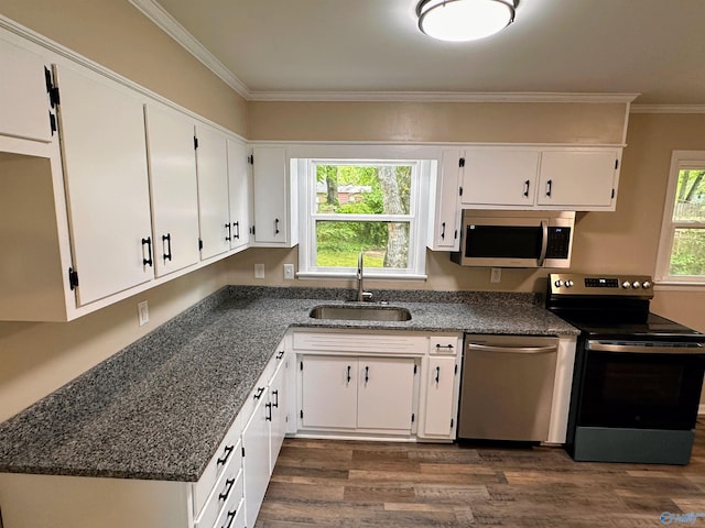 1701 Golf Club Ln NW, Huntsville, AL 35816 - kitchen featuring crown molding, white cabinets, a sink, stainless steel appliances, and dark wood-style floors