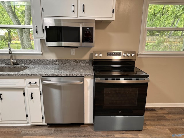 1701 Golf Club Ln NW, Huntsville, AL 35816 - kitchen with white cabinets, a wealth of natural light, appliances with stainless steel finishes, and a sink