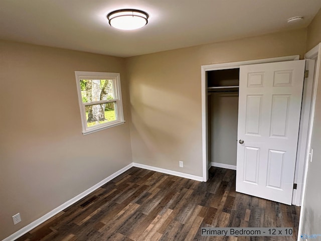 1701 Golf Club Ln NW, Huntsville, AL 35816 - unfurnished bedroom featuring dark wood-style floors, baseboards, and a closet