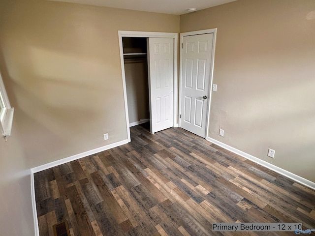 1701 Golf Club Ln NW, Huntsville, AL 35816 - unfurnished bedroom featuring dark wood-style floors, a closet, visible vents, and baseboards