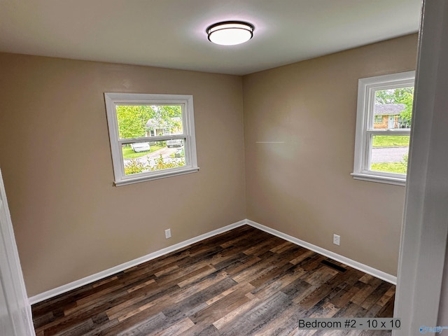 1701 Golf Club Ln NW, Huntsville, AL 35816 - empty room featuring dark wood-style flooring, visible vents, and baseboards