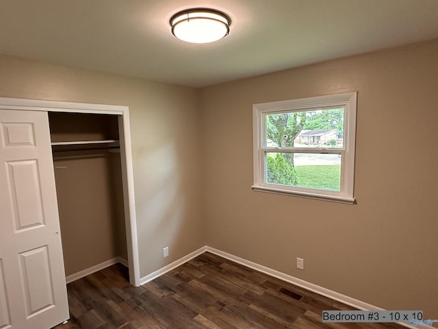 1701 Golf Club Ln NW, Huntsville, AL 35816 - unfurnished bedroom with baseboards, visible vents, a closet, and dark wood-type flooring