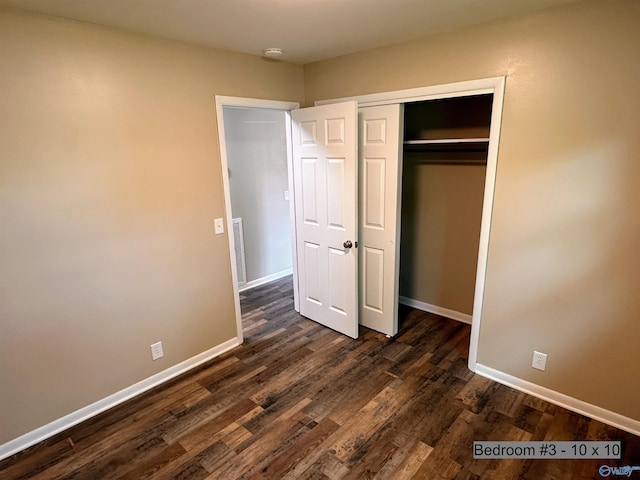 1701 Golf Club Ln NW, Huntsville, AL 35816 - unfurnished bedroom featuring dark wood-style floors, baseboards, and a closet