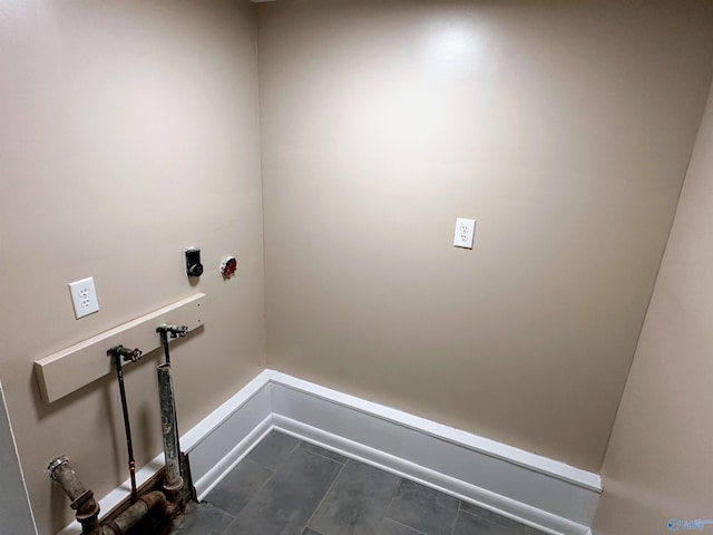 1701 Golf Club Ln NW, Huntsville, AL 35816 - clothes washing area with dark tile patterned floors, baseboards, washer hookup, and laundry area