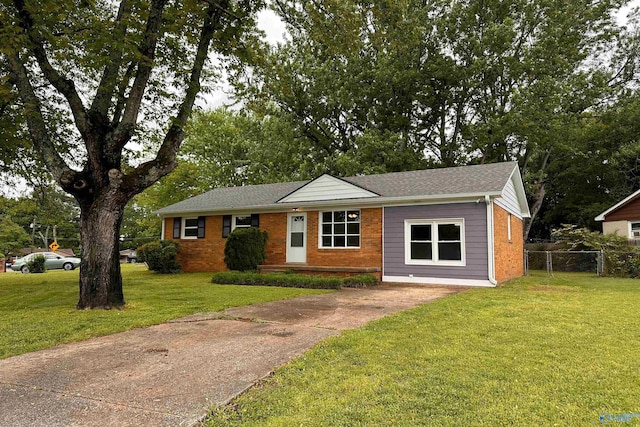 1701 Golf Club Ln NW, Huntsville, AL 35816 - view of front of property featuring brick siding, fence, roof with shingles, a front yard, and concrete driveway