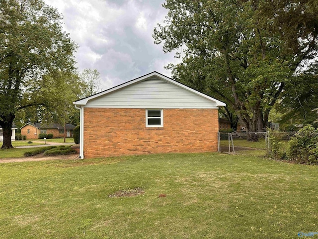 1701 Golf Club Ln NW, Huntsville, AL 35816 - view of side of property with a lawn, brick siding, and fence