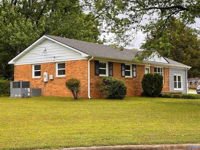 1701 Golf Club Ln NW, Huntsville, AL 35816 - view of front of house featuring a front lawn, central AC, a shingled roof, and brick siding
