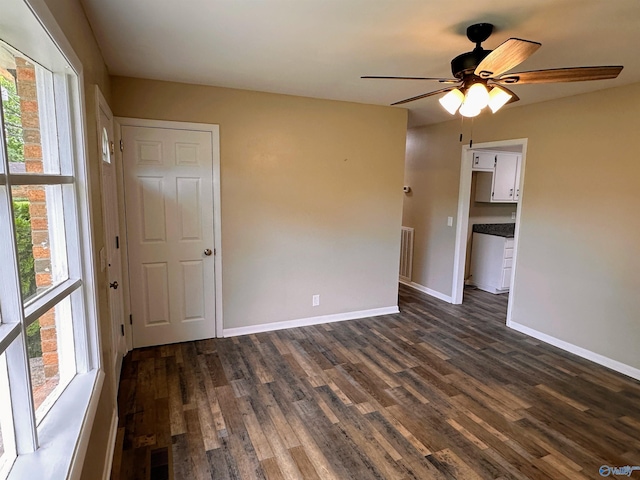 1701 Golf Club Ln NW, Huntsville, AL 35816 - spare room featuring baseboards, ceiling fan, and dark wood-type flooring