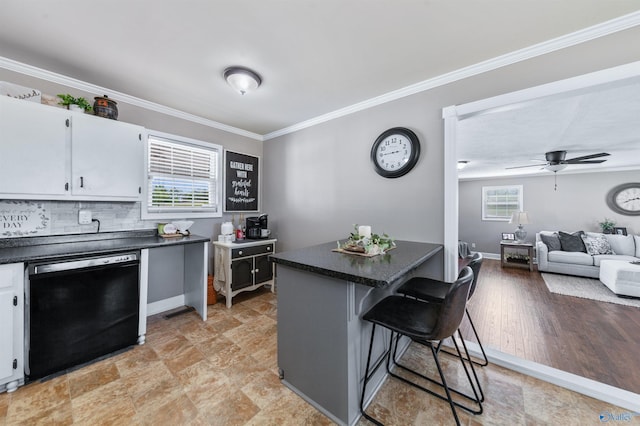 27906 Mooresville Rd, Elkmont, AL 35620 - kitchen with black dishwasher, dark countertops, ornamental molding, a breakfast bar, and white cabinets