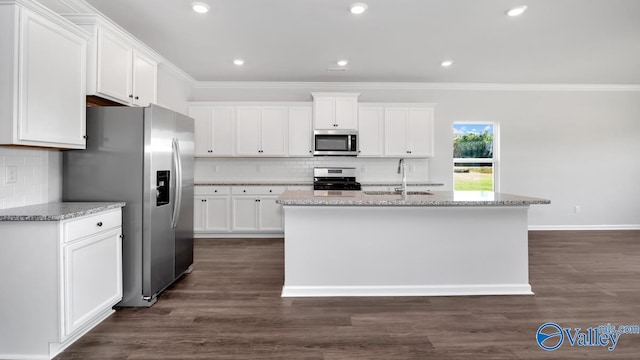 kitchen featuring appliances with stainless steel finishes, white cabinets, a center island with sink, and dark hardwood / wood-style flooring