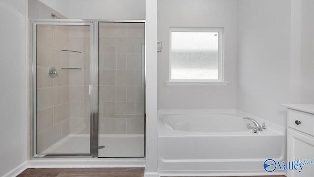 bathroom with vanity, hardwood / wood-style floors, and independent shower and bath