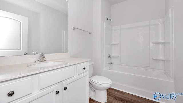 full bathroom with vanity, toilet, hardwood / wood-style flooring, and shower / bathing tub combination