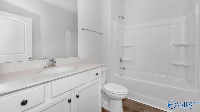 full bathroom featuring vanity, toilet, wood-type flooring, and washtub / shower combination