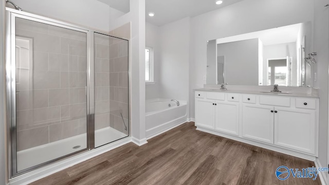 bathroom featuring vanity, hardwood / wood-style floors, and separate shower and tub