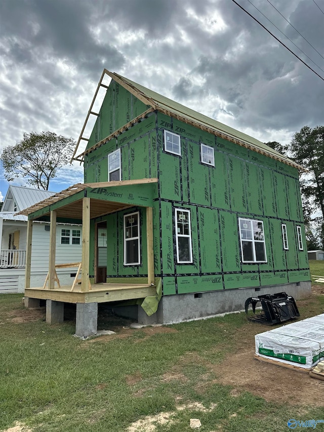 view of property exterior featuring a yard and covered porch