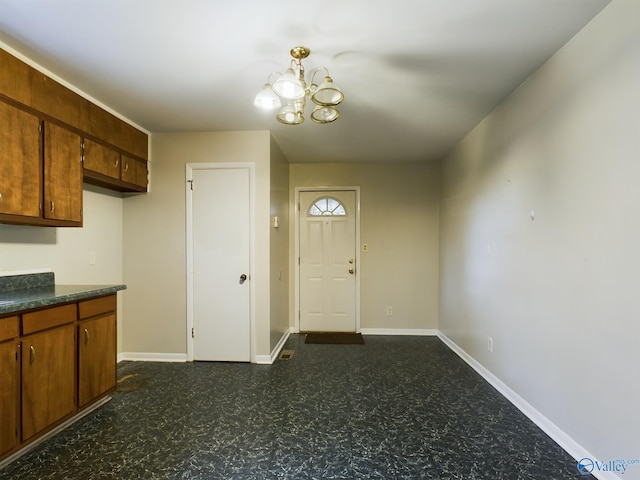 4227 Keith Dr NW, Huntsville, AL 35810 - kitchen with dark floors, a chandelier, dark countertops, and baseboards