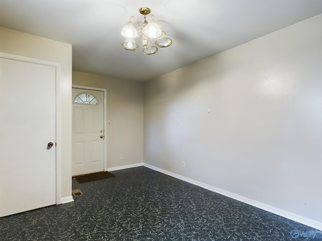 spare room with a notable chandelier