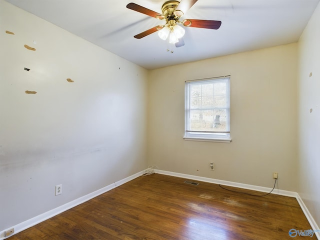 spare room featuring ceiling fan and dark wood-type flooring