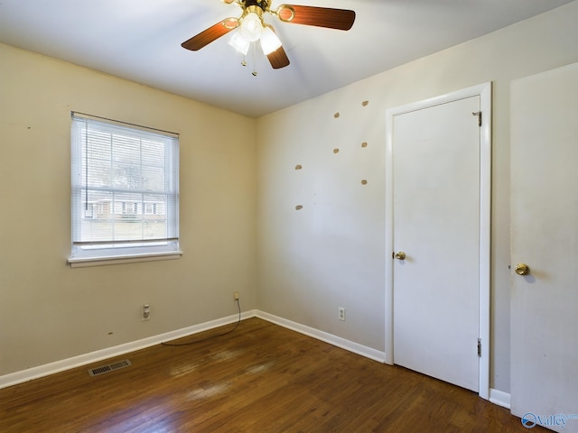 spare room featuring ceiling fan and dark hardwood / wood-style floors