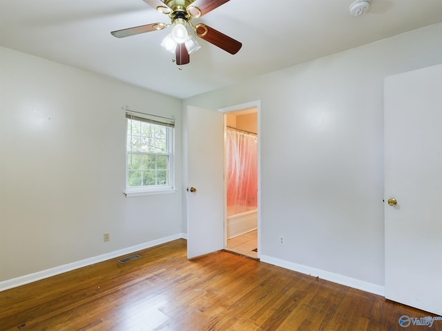 spare room featuring hardwood / wood-style floors and ceiling fan