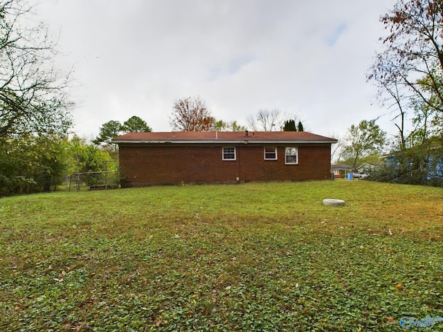 rear view of property with a lawn