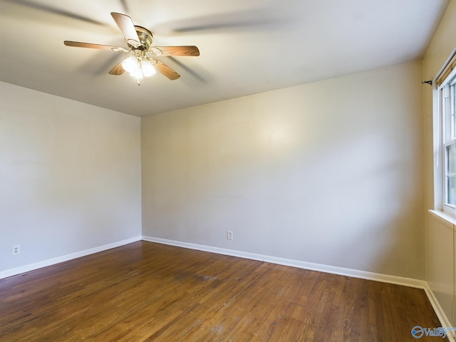 spare room featuring dark hardwood / wood-style floors and ceiling fan