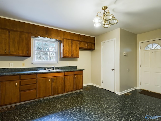 kitchen with sink and a notable chandelier